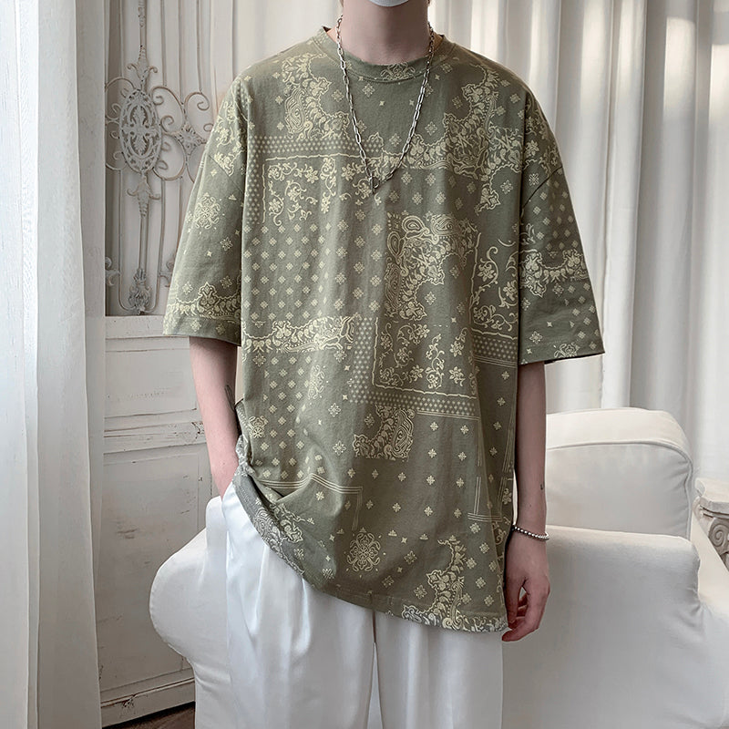Olive Green loose t-shirt with an all-over paisley bandana pattern, worn by a model, front view