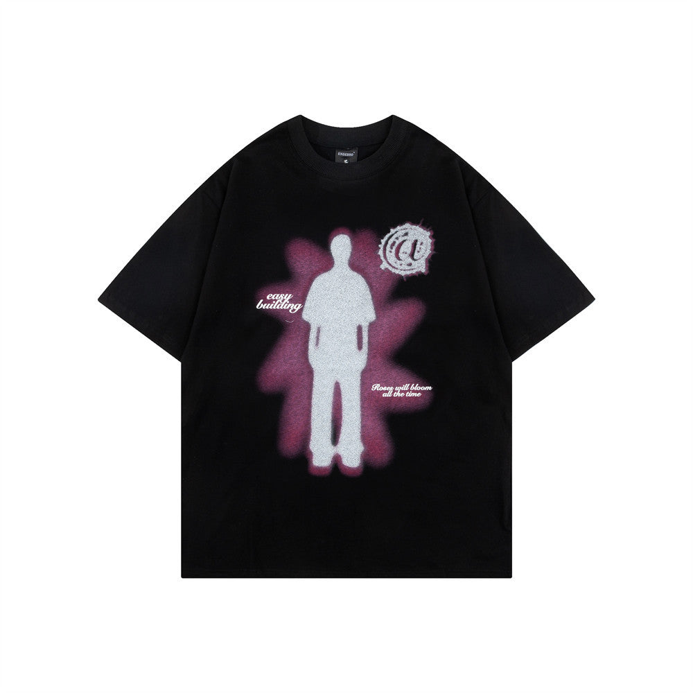 Black t-shirt with a silhouette and glow graphic on the front, flat lay, front view