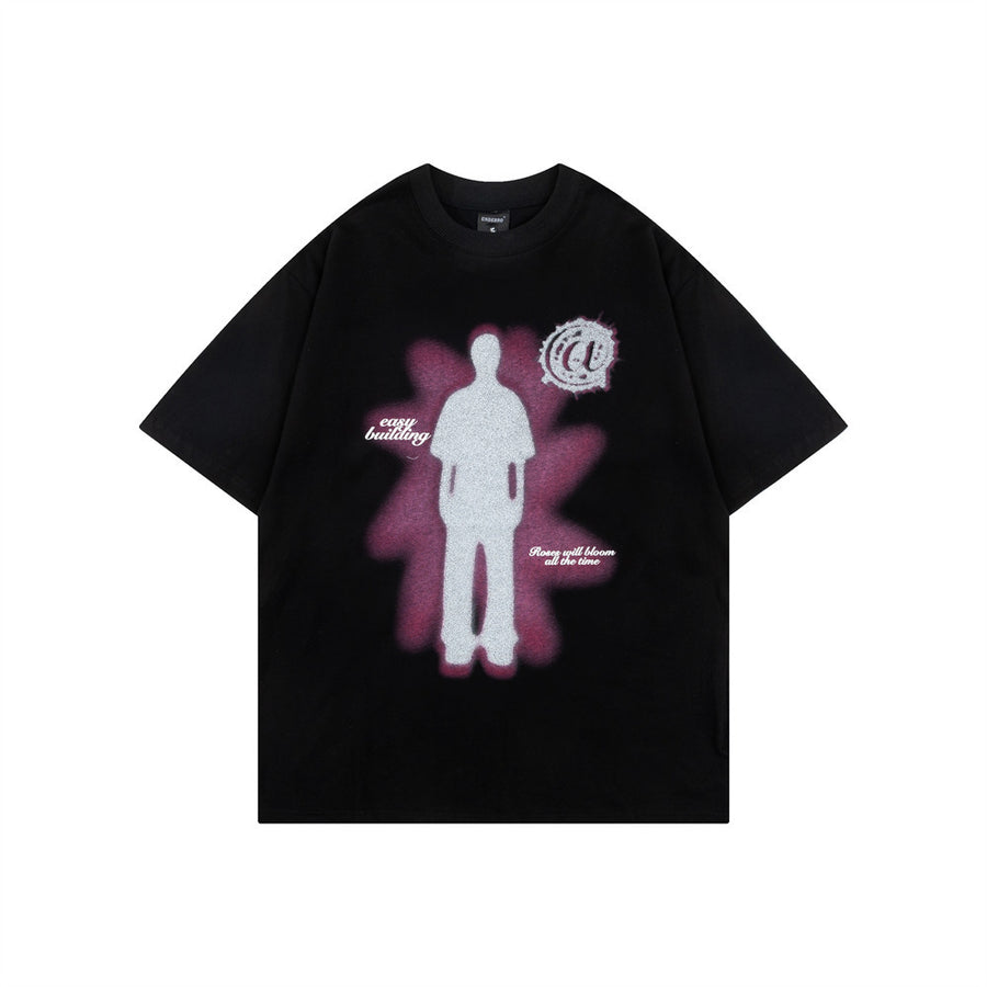 Black t-shirt with a silhouette and glow graphic on the front, flat lay, front view