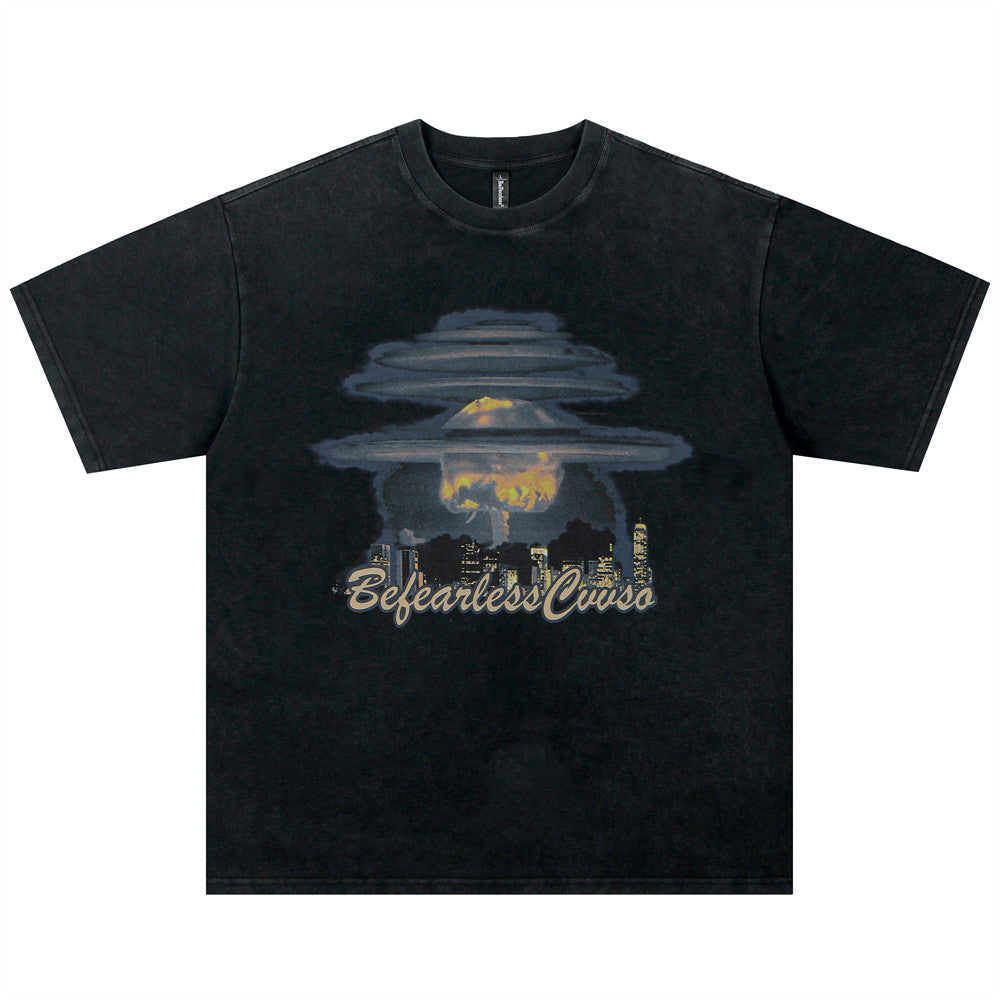 Washed Black washed t-shirt with a mushroom cloud skyline graphic on the chest, flat lay, front view