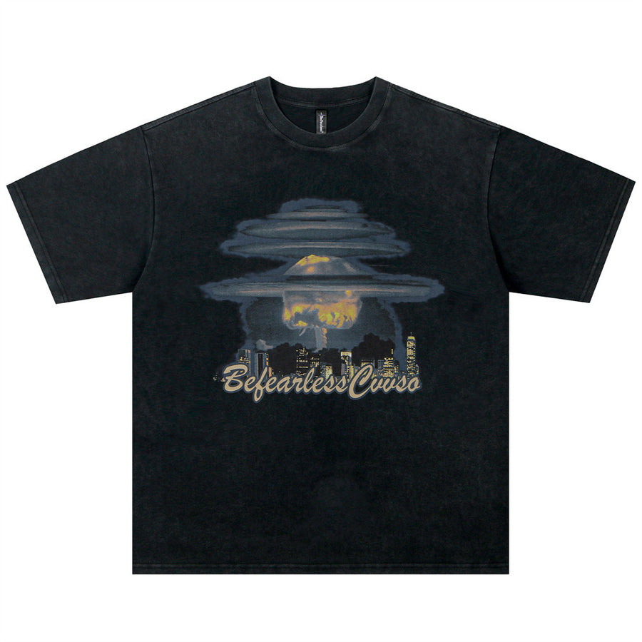 Washed Black washed t-shirt with a mushroom cloud skyline graphic on the chest, flat lay, front view