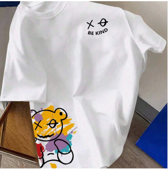 White t-shirt with a cartoon bear graphic at the hem and small text on the chest, flat lay, front view