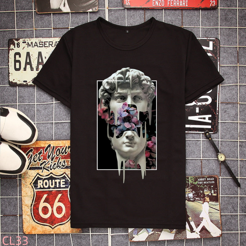 Black t-shirt with a sculpture head graphic and pink flowers on the chest, front view