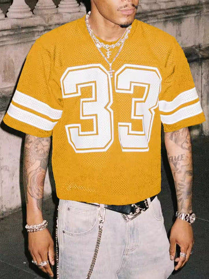 Mustard mesh sports t-shirt with a large number 33 and sleeve stripes, worn by a model, front view