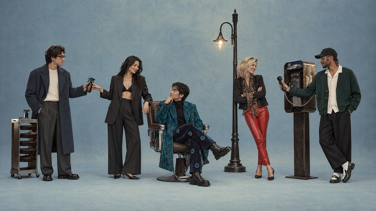Five FASVENA AI models in streetwear interacting on a blue studio set